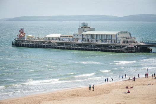 BOURNEMOUTH, UK - JUNE 14, 2013: Originally constructed in the 19th century, the pier remains one of the most popular tourist attractions of its type in Britain