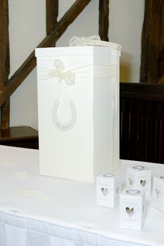 Weddind reception table detail with confetti boxes and lucky horse shoe