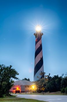 Diagonal black and white stripes mark the Cape Hatteras lighthouse at midnight