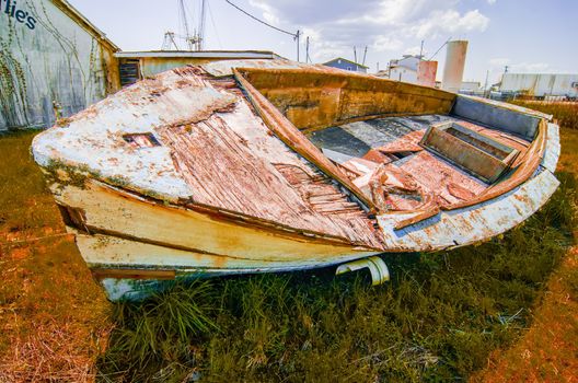 old rotten abandoned row boat on land