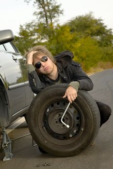 Man with wheel on the road