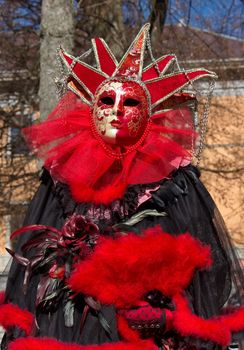 Red and black person at the 2014 venetian carnival of Annecy, France