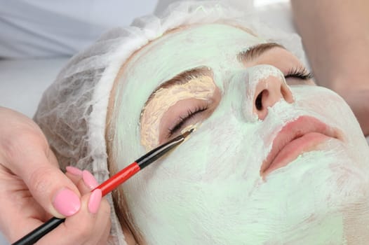 beauty salon, facial mask around eyes applying using brush