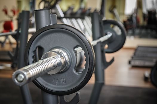 Barbell ready to workout, indooors, shallow DOF