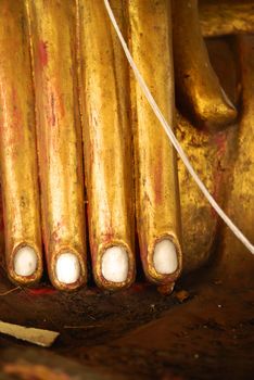 hand of ancient burmese style buddha image that made from stone at temple hall,Lampang temple,Thailand