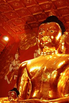 big buddha image at temple hall that made by real gold,Lampang temple,Thailand