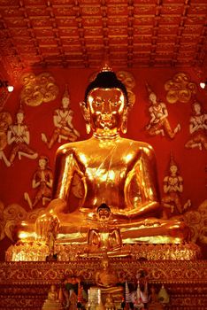 big buddha image at temple hall that made by real gold surrounding with angels,Lampang temple,Thailand