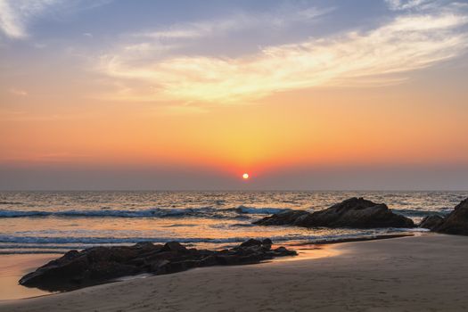 Scenic view from sand beach in Goa to beautiful sunset above the Arabian sea