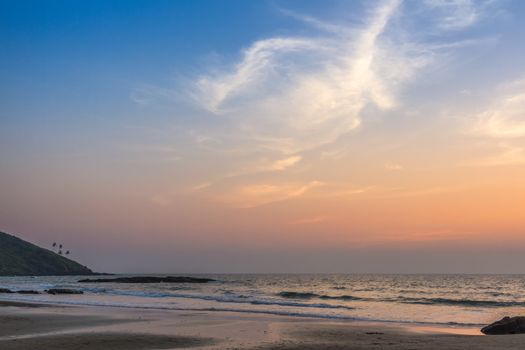 Scenic view from sand beach in Goa to beautiful sunset above the Arabian sea