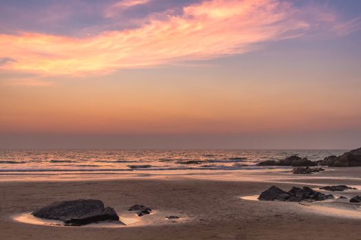 Scenic view from sand beach in Goa to beautiful sunset above the Arabian sea
