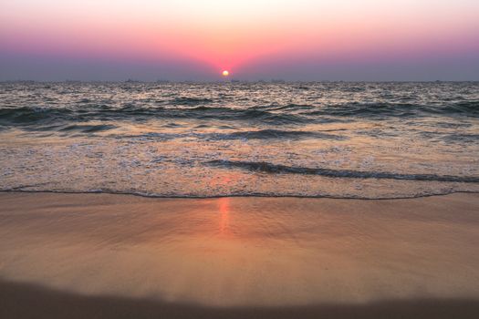 Scenic view from sand beach in Goa to beautiful sunset above the Arabian sea