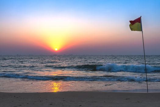 Scenic view from sand beach in Goa to beautiful sunset above the Arabian sea