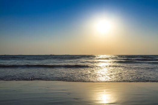 Scenic view from beach in Goa to beautiful sunrise above the Arabian sea. Sun reflection on sea surface