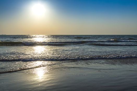 Scenic view from beach in Goa to beautiful sunrise above the Arabian sea. Sun reflection on sea surface