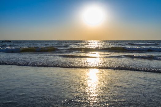 Scenic view from beach in Goa to beautiful sunrise above the Arabian sea. Sun reflection on sea surface