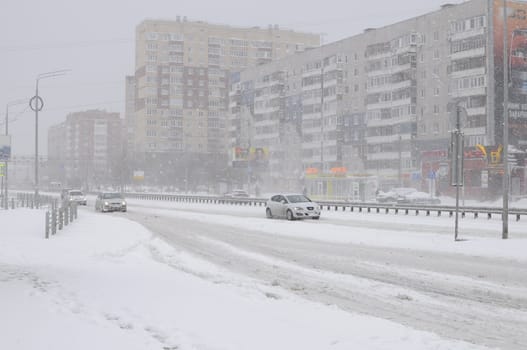 The cars brought by snow, stand on a road roadside