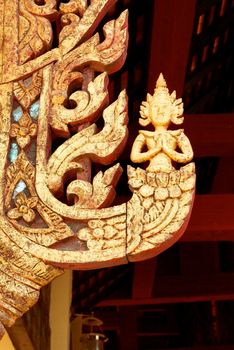 the detail of thai pattern ,show handmade wood carving work and decorated with gold plate,mirror and precious stone,Lampang temple,Thailand