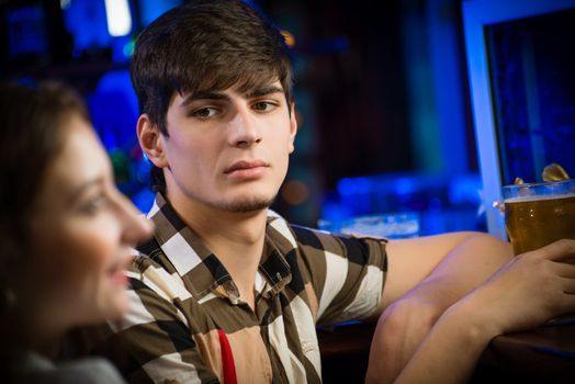 portrait of a young man at the bar, spending time in a nightclub