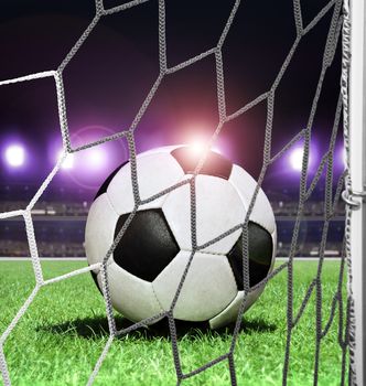 closeup soccer ball on green grass of night stadium
