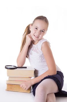 Happy schoolgirl with pile of books isolated on white