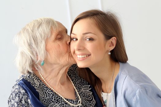 Close-up. Elderly woman and beautiful granddaughter with wide smile