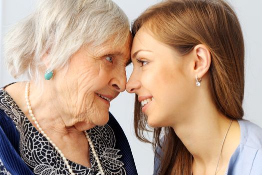 Close-up. Elderly woman and beautiful granddaughter with wide smile