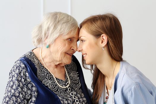 Close-up. Elderly woman and beautiful granddaughter with wide smile