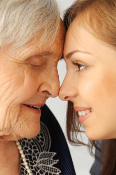 Close-up. Elderly woman and beautiful granddaughter with wide smile