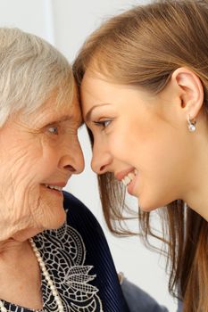 Close-up. Elderly woman and beautiful granddaughter with wide smile