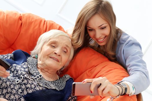 Elderly woman and beautiful granddaughter with wide smile