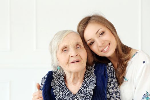 Close-up. Elderly woman and beautiful granddaughter with wide smile