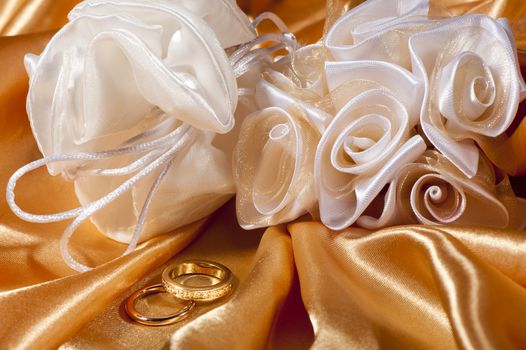  wedding rings on  a colorful fabric background