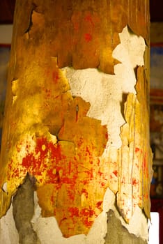 ancient golden pillar showing of gold plate distraction from main structure,Lampang temple,Thailand