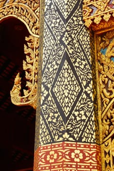 the detail of  thai gold painting pattern on ancient temple pillars ,shallow focus,Lampang temple,Thailand