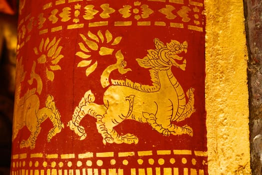 the detail of  thai gold painting pattern on ancient temple pillars ,shallow focus,Lampang temple,Thailand