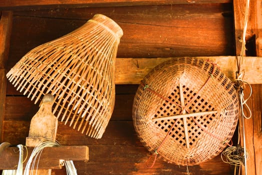 used traditional thai basketwork hanging on wooded wall