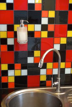 hand wash sink decorated with colourful mosaic tiles