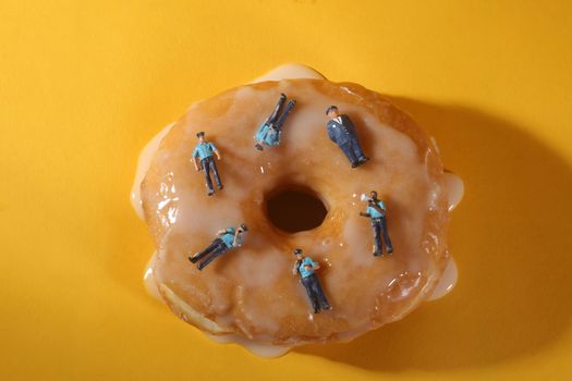 Miniature Police Officers in Conceptual Food Imagery With Donuts