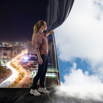 image of a young woman pushes the curtain looking at clouds