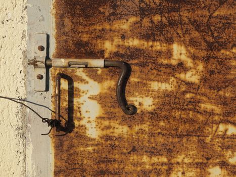 Old rusty door with rusted handle     