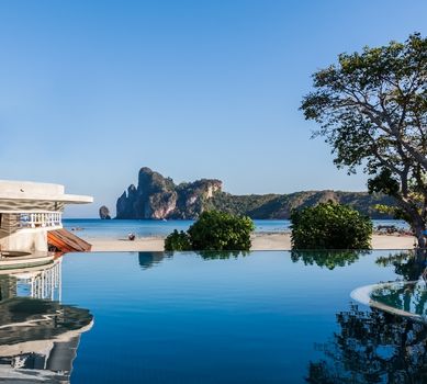 Swimming pool near beach with mountain view.