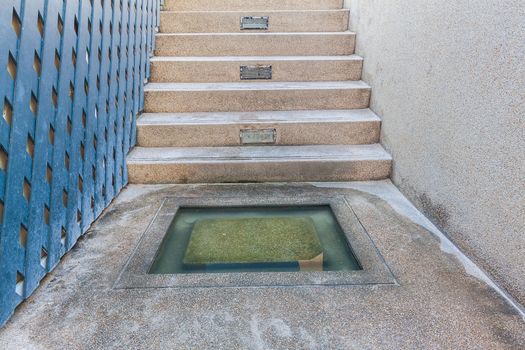 Water in cement hole for cleaning foot before swim in swimmingpool