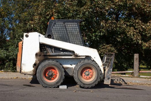 small excavator Bobcat parked at construction site