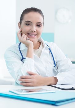 Portrait of a beautiful young female doctor or pharmacist in office
