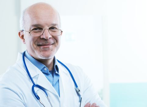 Friendly doctor smiling and looking at camera.