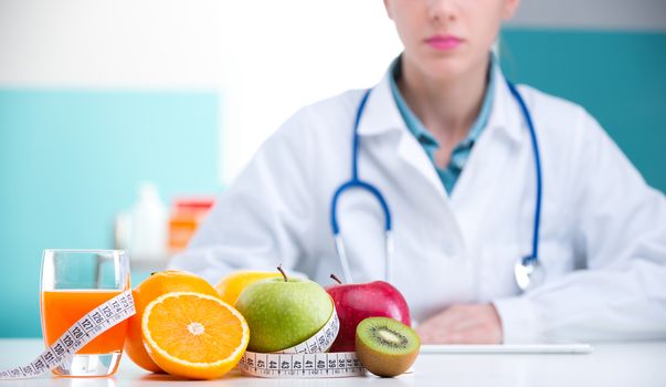 Healthcare professional promoting healthy eating, focus on fruit