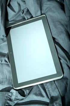 A Tablet PC on some dark cloth.