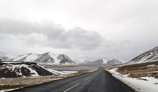 the road to  snaefellsne on the island iceland with lake and mountains in winter