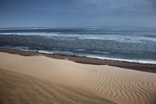 Sandy desert and sea. Horizontal photo