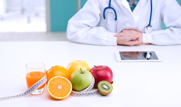 Healthcare professional promoting healthy eating, focus on fruit